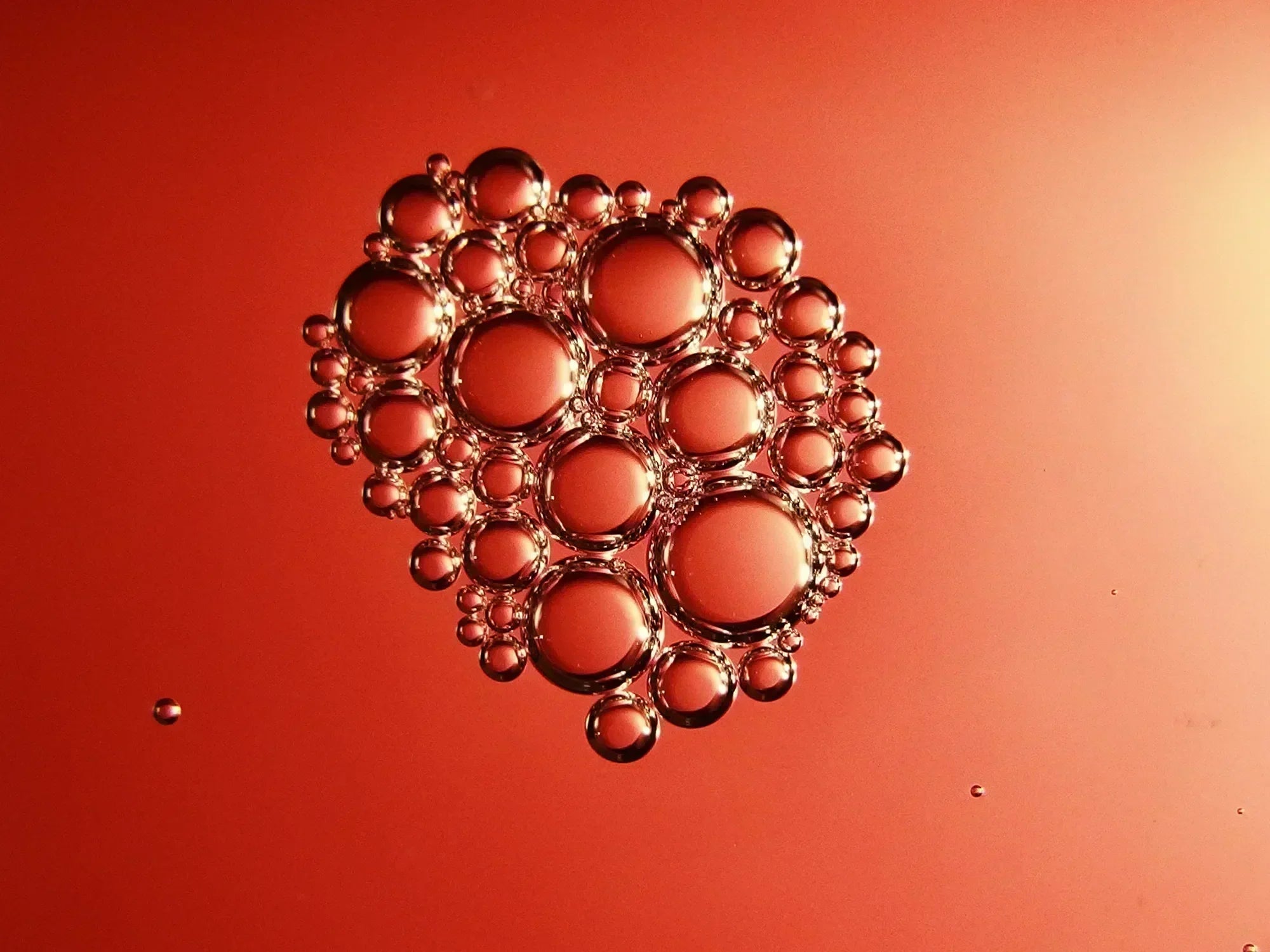 Close-up of transparent bubbles in liquid against a copper-colored background, research peptide concept